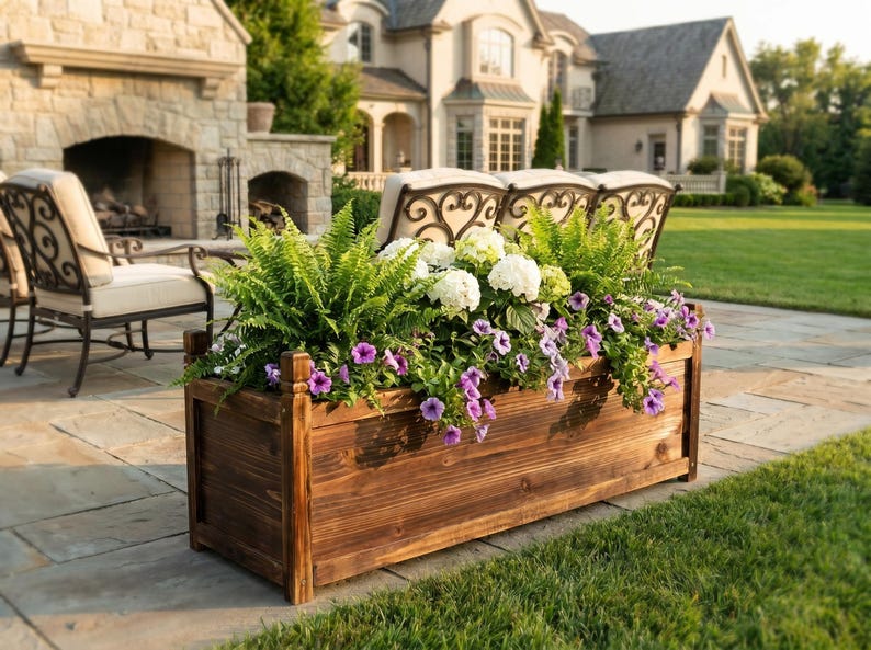 Solid pine garden planter filled with soil and small plants outdoors