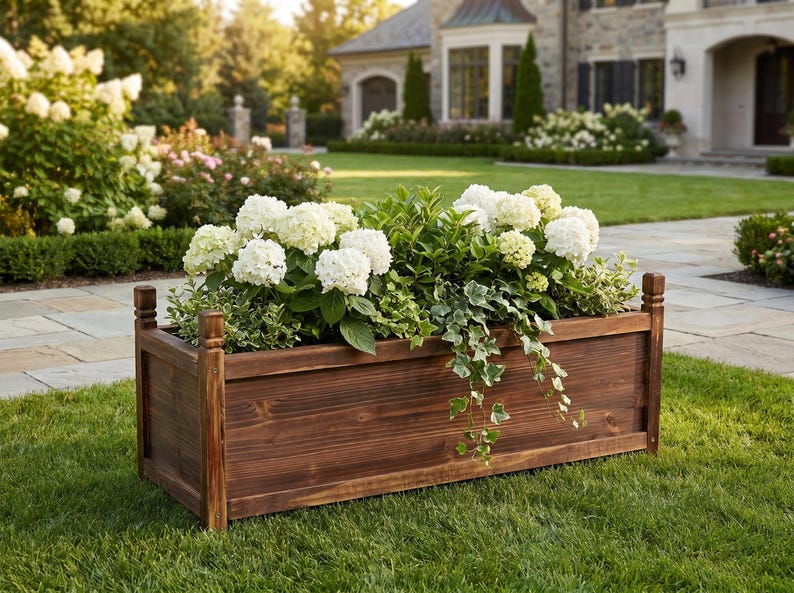 Wood raised planter box placed on green lawn with plants inside