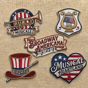 May include: A white ceramic mug with a black handle and the text "But First, Coffee" in a black, bold font. The mug is on a white surface.