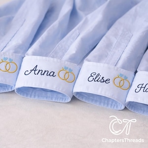 May include: Light blue dress shirts with embroidered names and wedding ring designs on the cuffs. The names "Anna" and "Elise" are visible. The ChaptersThreads logo is in the bottom right corner.