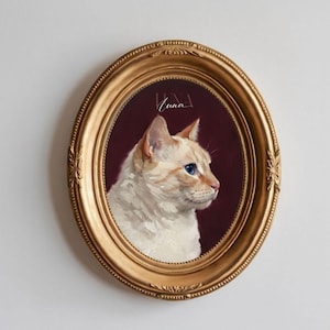 May include: Oval, gold-framed portrait of a white cat with blue eyes, set against a burgundy background. The cat is painted in profile, with the name "Luna" written in cursive above the cat's head.