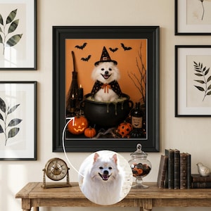 May include: A framed wall art print featuring a white dog wearing a black witch hat and cape, sitting inside a black cauldron. The scene includes orange pumpkins, a broomstick, and bats against an orange background. A circular inset shows the dog.