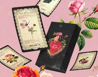 May include: A black tarot card deck box labeled "Moonlight Tarot Vol 1" with a heart-shaped illustration, surrounded by floating tarot cards featuring floral designs, "The Fool," "Ace of Swords," and "The Empress," accented by pink and orange roses.