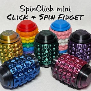 May include: A collection of six SpinClick mini CLICK + SPIN FIDGET toys in various colors including red, blue, green, purple, and gold. Each cylindrical fidget device features a textured, dimpled surface and a circular top button for tactile interaction.