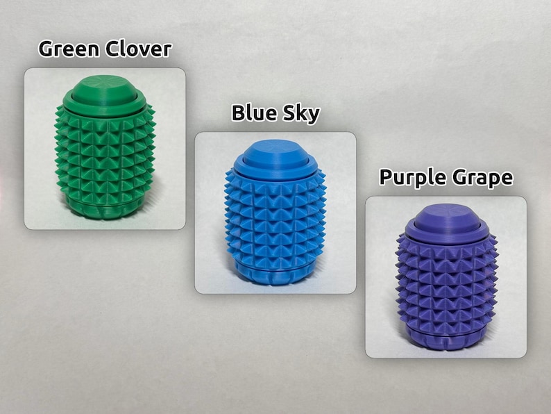 May include: Three cylindrical sensory fidget tools with a textured, spiked surface. The green one is labeled Green Clover, the blue one is labeled Blue Sky, and the purple one is labeled Purple Grape. Each item features a smooth, flat circular top.