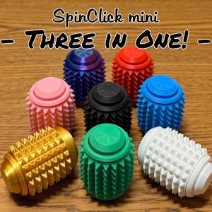 May include: A collection of colorful, spiky, egg-shaped fidget toys. The toys are in various colors, including gold, green, white, blue, red, pink, black, and a blue-purple gradient. The text "SpinClick mini - THREE IN ONE! -" is at the top.