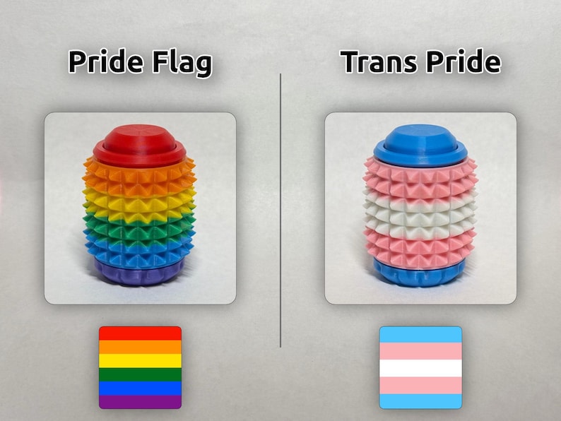 May include: Two cylindrical sensory rollers with spiked textures. The left roller features horizontal stripes of red, orange, yellow, green, blue, and purple, labeled Pride Flag. The right roller has blue, pink, and white stripes, labeled Trans Pride.