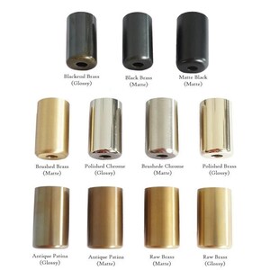 May include: An assortment of cylindrical metal hardware in various finishes, including black, brass, and chrome. The image displays samples labeled "Blackend Brass," "Black Brass," "Matte Black," "Brushed Brass," "Polished Chrome," "Brushede Chrome," "Polished Brass," "Antique Patina," and "Raw Brass."