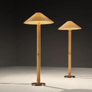 May include: Two bamboo floor lamps with conical woven shades. The lamps have a natural wood finish and a round base. The shades are lit from within, casting a warm glow. The lamps are of different heights.