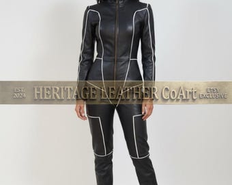 May include: A black leather jumpsuit featuring a high collar, a full-length front zipper, and long sleeves. The garment is accented with white piping along the shoulders, torso, and legs. The text HERITAGE LEATHER CoArt EST. 2024 ETSY EXCLUSIVE is visible.