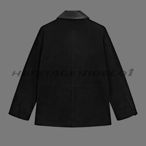 May include: Black jacket with a leather collar. The jacket has long sleeves and a classic design. The text "HERITAGEHIDECO1" is printed across the bottom of the jacket. The jacket is displayed against a gray background.