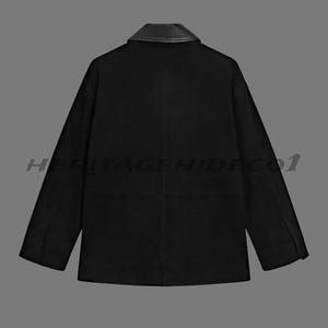 May include: Black jacket with a leather collar. The jacket has long sleeves and a classic design. The text "HERITAGEHIDECO1" is printed across the bottom of the jacket.