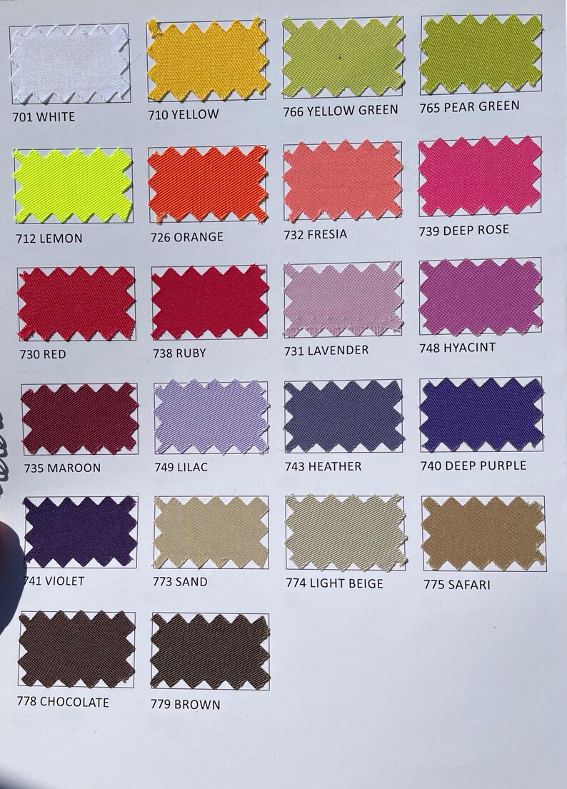 May include: A color chart featuring fabric swatches in various shades. The swatches are labeled with numbers and color names, including white, yellow, green, orange, red, purple, and brown. The image is well-lit, showcasing the diverse color palette.