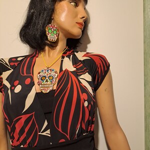 Sugar Skull pendant and earring set. Great for Halloween or Day of the Dead. Unique, hand-crafted from fabric, paper and resin.