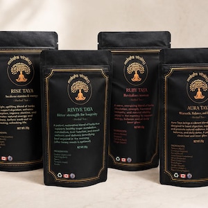 May include: Four black pouches of herbal tea, each with a gold label and the brand name "Roots of Vitality". The pouches are labeled "Rise Taya", "Revive Taya", "Ruby Taya", and "Aura Taya". Each pouch contains 25g of tea.