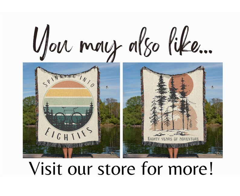 May include: Two woven throw blankets with nature-themed designs. One features a bicycle and the text "Spinning into Eighties" within a sunset circle. The other displays trees and a sun with the text "Eighty Years of Adventure".