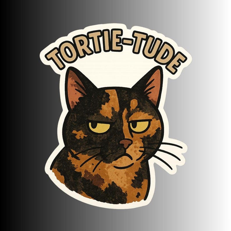 May include: A sticker featuring a grumpy-looking tortoiseshell cat with the word "TORTIE-TUDE" above its head. The cat has black, brown, and orange fur, with yellow eyes and a slightly annoyed expression.