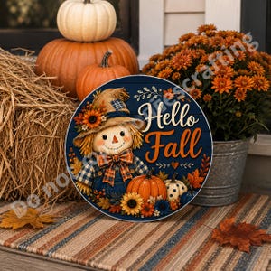 Fall farmhouse welcome decor with scarecrow character, pumpkin garden, sunflower border, and orange leaves.