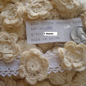 May include: A close-up of a bag of 100% cotton crochet flowers. The bag contains a dozen cream-colored flowers. The label reads "100% Cotton Crochet Flower, Art No. 1500, Q'th: 1 dozen, Made in China".