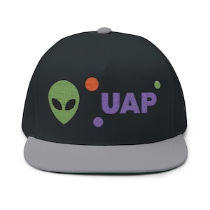 May include: Black flat-peak cap with a grey peak and a green alien head embroidered on the front. The word "UAP" is embroidered in purple, with orange and purple dots. The cap has a grey button on top.
