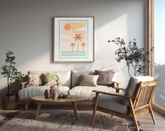 May include: A framed art print depicting a beach scene with palm trees, sun, and waves hangs above a light-colored sofa. The room features a wooden coffee table, armchair, and a patterned rug, creating a relaxed living room setting.