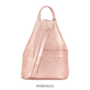 May include: Rose gold backpack with a top handle and a front pocket. The bag has a diagonal seam across the front and the word "ROSEGOLD" printed at the bottom.