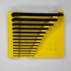 Top-down view of a yellow 3D-printed Bondhus inch Allen wrench organizer tray containing 13 black hex keys. The tray features a built-in magnetic parts area on the right. Each wrench slot is labeled with embossed inch sizes from .05" to 3/8".