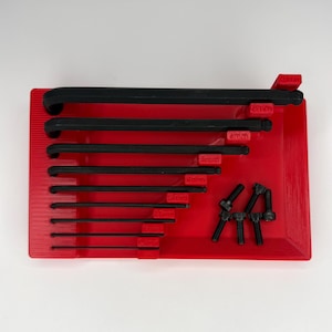 May include: A red plastic tool organizer holding a set of black Allen wrenches and several black bolts. The wrenches are labeled with sizes from 2mm to 8mm. The organizer has a rectangular shape.