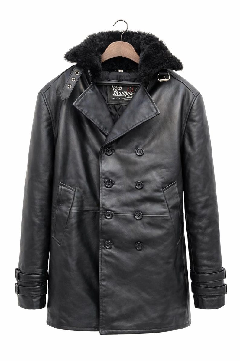 May include: Black leather coat with a faux fur collar. The double-breasted coat features a notched lapel, multiple buttons, and adjustable cuffs. The label reads "Real Leather".