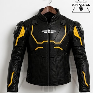 May include: A black leather jacket featuring yellow accents, shoulder armor plates with skull emblems, and a central chest emblem with wings and a skull. The jacket has a high collar, a full-length front zipper, and Darkline Apparel branding.