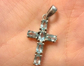 Oval cut natural Swiss blue topaz cross pendant in sterling silver