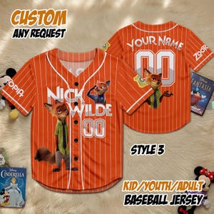 May include: Orange baseball jersey with white pinstripes, featuring Nick Wilde from Zootopia. The jersey has the text "NICK WILDE 00" on the front and "YOUR NAME 00" on the back. Additional text includes "CUSTOM ANY REQUEST" and "KID/YOUTH/ADULT BASEBALL JERSEY".