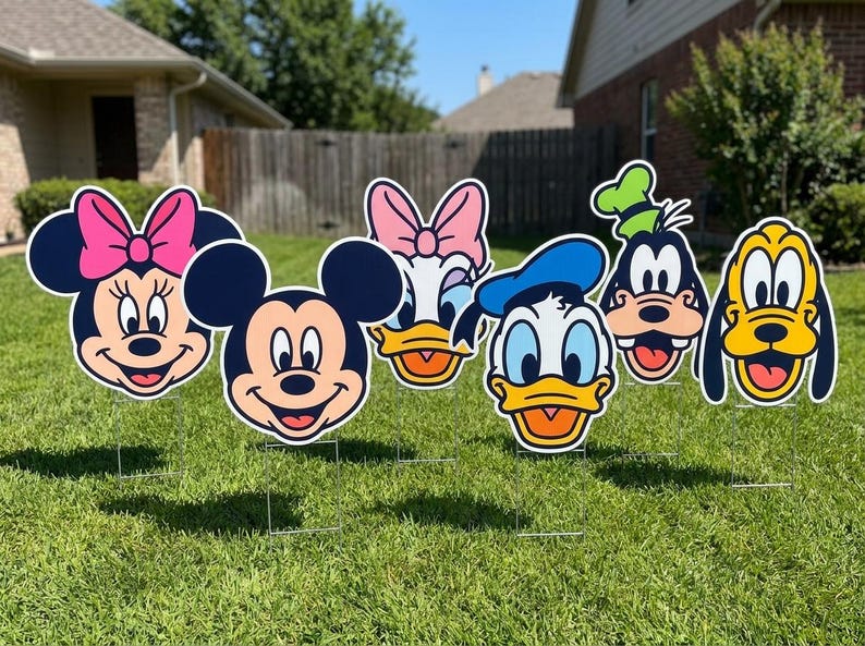 May include: A set of six colorful yard signs featuring the faces of Minnie Mouse, Mickey Mouse, Daisy Duck, Donald Duck, Goofy, and Pluto. Each character cutout is mounted on a thin metal stake, displaying iconic features and expressions.