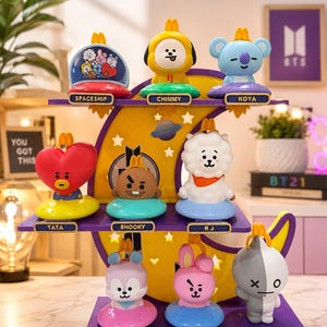 May include: A multi-tiered purple display stand featuring eight BT21 character figures: Spaceship, Chimmy, Koya, Tata, Shooky, RJ, Mang, Cooky, and Van. The stand has a yellow crescent moon backdrop with star cutouts and the text ARMY FOREVER.