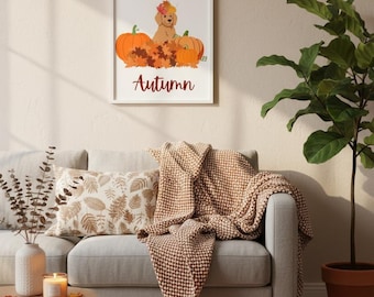 May include: A cozy living room scene with a framed print reading "Hello Autumn" above a gray sofa. A brown throw blanket and decorative pillows add warmth. A carved pumpkin and gourds sit on the floor, with a potted plant to the right.