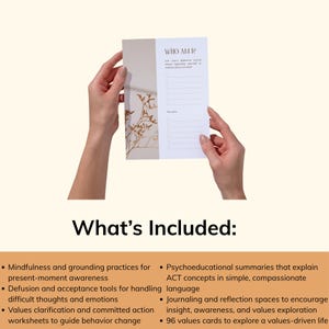 May include: A white and beige journal page with the text "WHO AM I?" and a list of prompts. The page is held by hands against a neutral background. The journal page has a floral design on the left side.