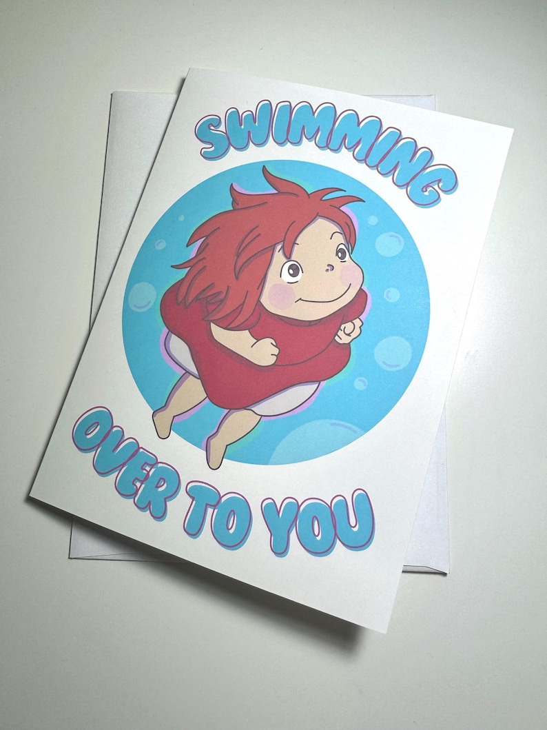 K&ouml;nnte beinhalten: Gru&szlig;karte mit einer Cartoonfigur mit roten Haaren und rotem Kleid, vor blauem Hintergrund mit Blasen. Der Text "SWIMMING OVER TO YOU" ist blau. Inklusive wei&szlig;em Umschlag.