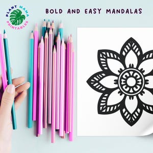May include: A black and white mandala coloring page with a flower design. The page is surrounded by a variety of colored pencils.