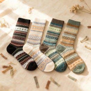 May include: Four pairs of patterned socks in various colours. The socks feature geometric and tribal designs in shades of black, white, brown, blue, and green. The socks are made of a soft, knitted material, ideal for cold weather.