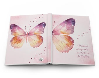 May include: Open journal with a watercolor butterfly design. The butterfly wings are pink, purple, and orange. The journal's cover has the text "Without change there would be no butterflies."