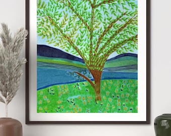 May include: A framed watercolor painting featuring a large tree with vibrant green leaves centered in a landscape. The scene includes a bright green grassy field with yellow flowers, a blue body of water, and dark blue rolling hills under a light blue sky.