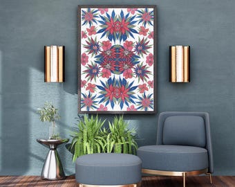 May include: A framed rectangular wall art piece featuring a symmetrical floral pattern with red, blue, and green botanical motifs on a white background, displayed above a blue upholstered armchair and a matching round ottoman on a wooden floor.