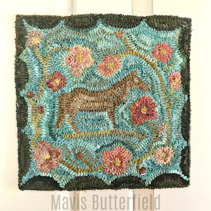 May include: A hand-hooked rug with a brown horse design surrounded by teal blue and pink flowers. The rug has a dark green border and the artist's signature "Mavis Butterfield" is written below the rug.