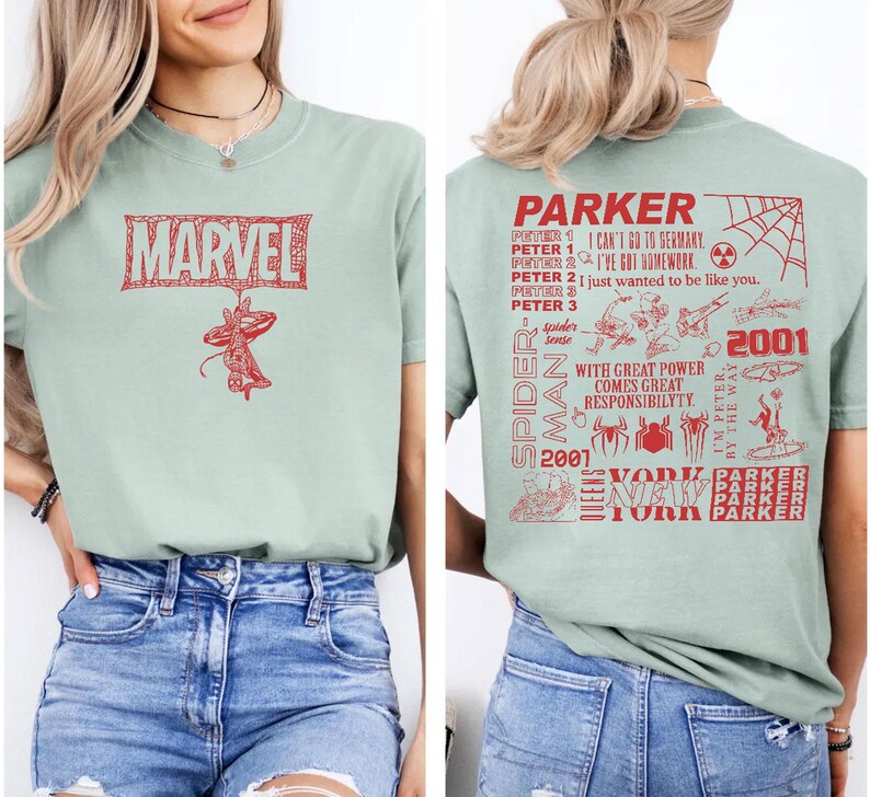 May include: A light green t-shirt featuring a red Marvel logo and a Spider-Man graphic. The back of the shirt has a Spider-Man design with text that reads "Parker" and "2001".