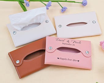 May include: Four leather tissue box covers in white, brown, and pink. One white cover is open, revealing tissues. The pink cover is inscribed with "David & Nicole, September 20" and "Happily Ever After."
