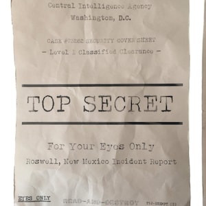 May include: A weathered document with the words "TOP SECRET" in bold print. The paper is creased and bears text from the Central Intelligence Agency, referencing a Roswell, New Mexico incident report, with the words "For Your Eyes Only".