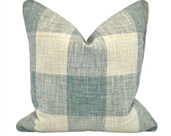 May include: A soft, light blue and white checkered throw pillow with a subtle woven texture.