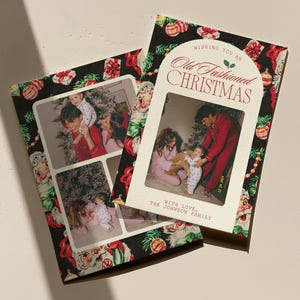 May include: Two Christmas cards featuring family photographs. One card has a black background with a festive pattern of Santa Claus, baubles, and holly. The other card has a white background with the text "Wishing You an Old Fashioned Christmas."