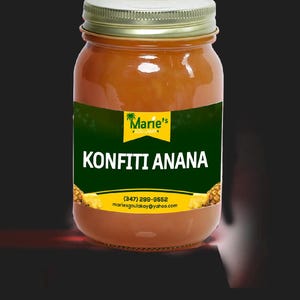 May include: A jar of Konfiti Anana, a product from Marie's Gou Lakay. The jar has a gold lid and a green label with the product name in large white letters. The jar contains a golden-brown preserve.