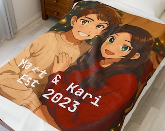 May include: A personalized blanket featuring an anime-style illustration of a couple. The blanket has the text "Matt & Kari 2023" and "Est" printed on it. The couple is smiling, and the blanket is tan and red.
